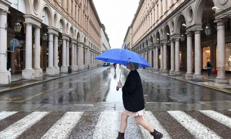ragazza sotto la pioggia con ombrello blu