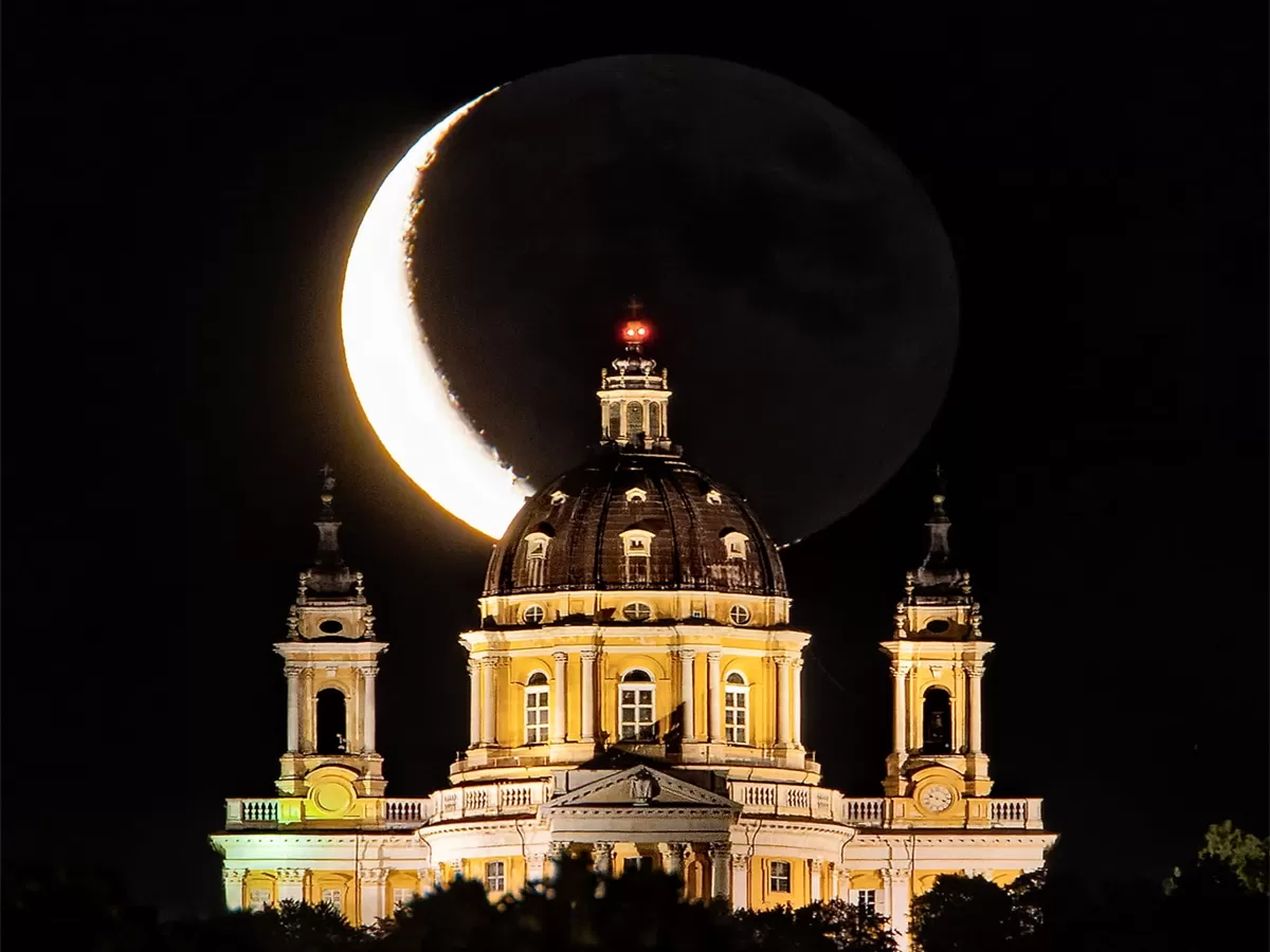 eclissi lunare sopra la basilica di Superga illuminata di notte