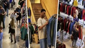Visitatori esplorano stand di abbigliamento vintage al mercato europeo 2025 di Torino, tra jeans, giacche retrò e t-shirt anni '90