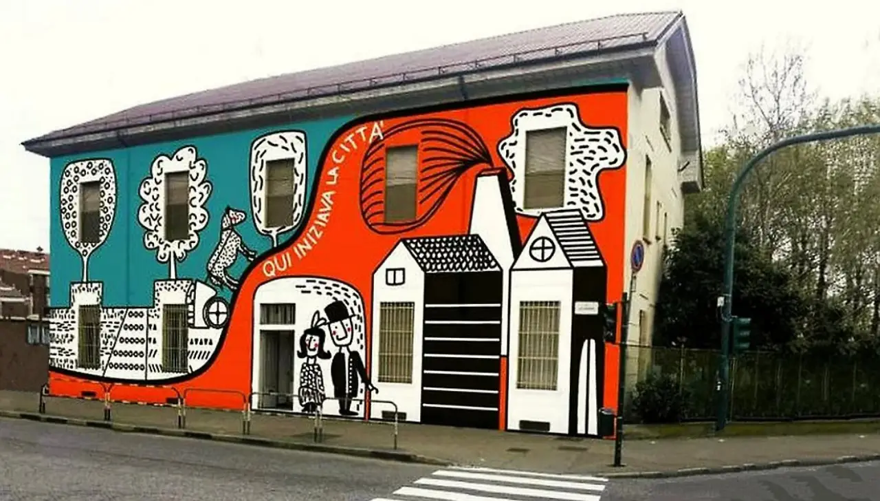 Facciata della scuola dell’infanzia Parri-Vian a Torino decorata con un murales colorato e la scritta “Qui iniziava la città